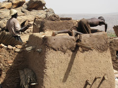 Dogon houses require occasional maintenance work