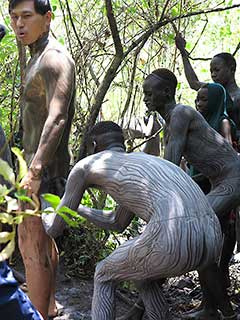 Bodypainting in preparation for the Surma stickfighting : friends paint friends (with mud)