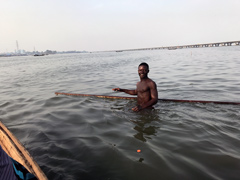 An inhabitant of Makoko, a " Floating Slum " or shanty town on stilts in the center of Lagos